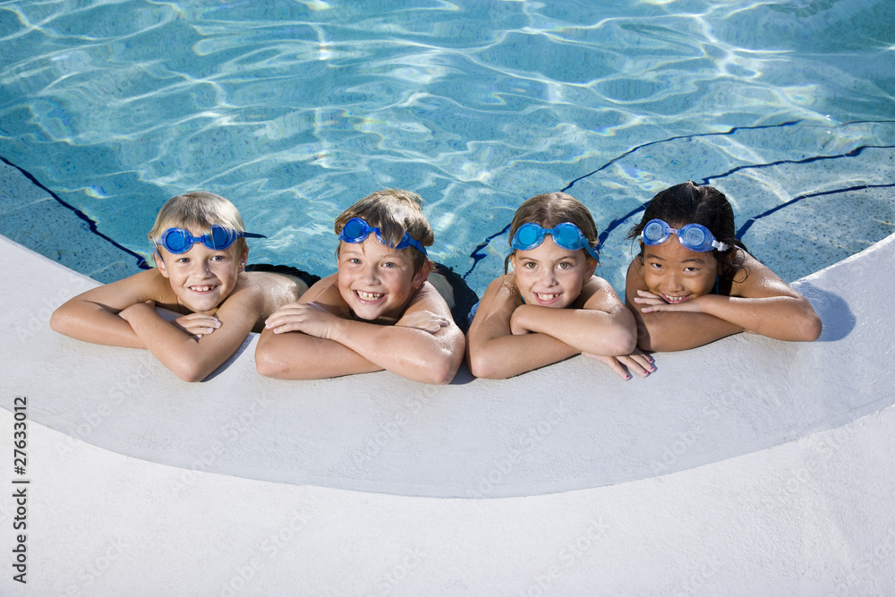 Wall mural children smiling at edge of swimming pool