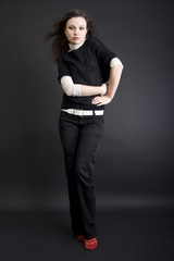 full-length portrait of a young brunette over black