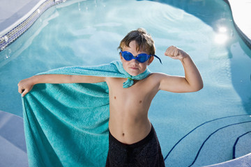 Boy superhero protecting the pool