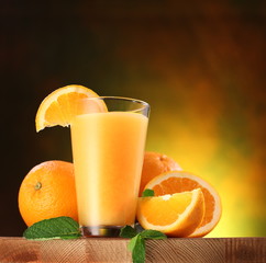 Oranges and glass of juice.