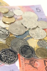 Australian banknotes and coins on plain white background