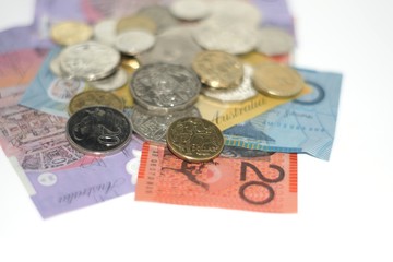 Australian banknotes and coins on plain white background