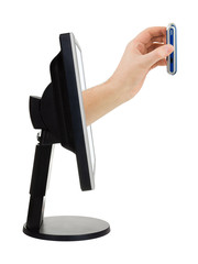 Computer screen and hand with phone