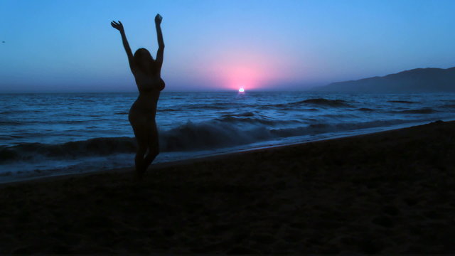 Young woman dances on beach - HD