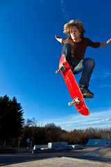 boy going airborne with his skateboard