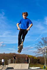 boy going airborne with his scooter