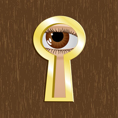 Door keyhole of golden metal with eye