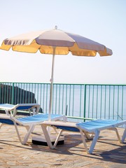 Sunbeds with parasol and view
