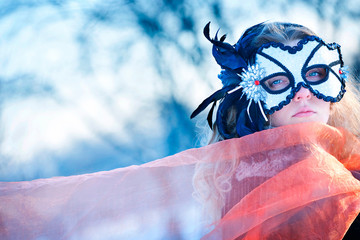 Portrait of beautiful young woman wearing  carnival mask