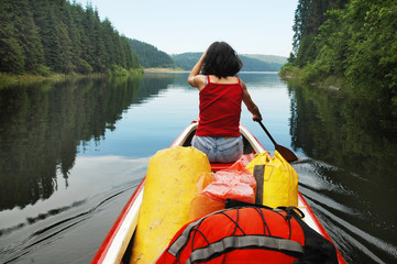 Canoeing girl on a lake
