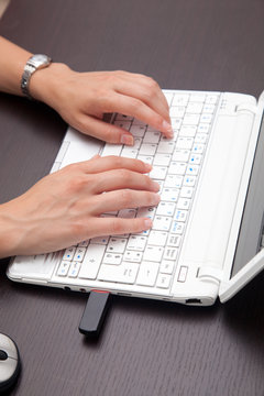 Woman hands typing on the laptop