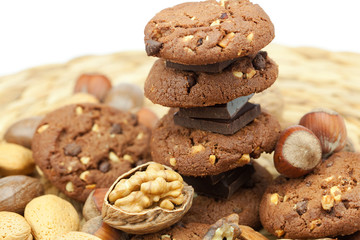 oatmeal cookies, chocolate and nuts on a wicker mat