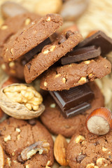 oatmeal cookies, chocolate and nuts on a wicker mat