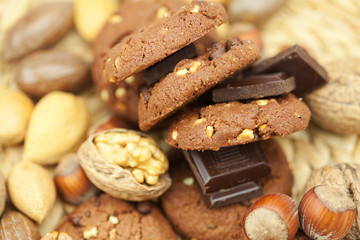 oatmeal cookies, chocolate and nuts on a wicker mat