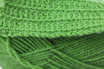 Skein of wool and knitted piece  background