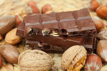 bar of chocolate and nuts on a wicker mat