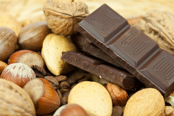 bar of chocolate and nuts on a wicker mat
