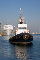 Tugboat returning to base, after towing a cruise ship