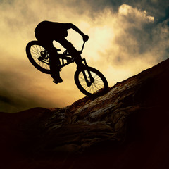 Fototapeta na wymiar Silhouette of a man on muontain-bike, sunset