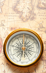 Old compass on ancient map