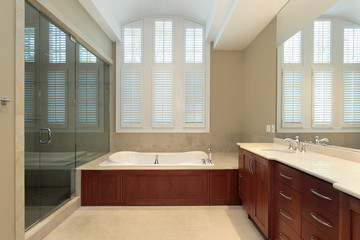 Master bath with wood paneled tub