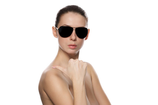 Portrait of woman in sunglasses shows the rigth.
