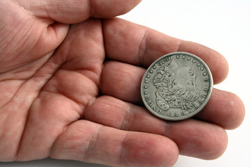 hand with dollar silver coin