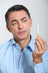 Closeup of man trying to quit smoking