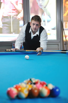 young man play pro billiard game
