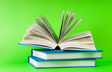 Stack of books on the color background