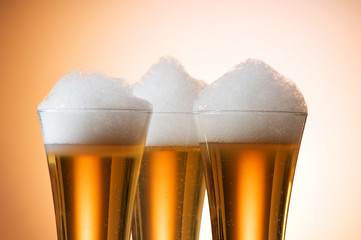 Beer glasses against the colorful gradient background