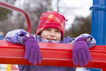 Fototapeta na wymiar girl on playground smiling