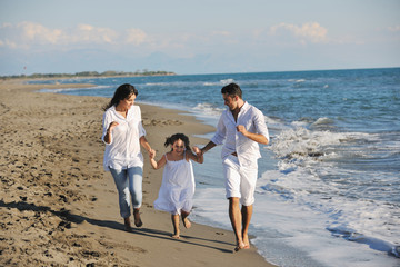 happy young  family have fun on beach
