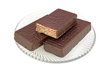 Sweet wafles in chocolate on plate