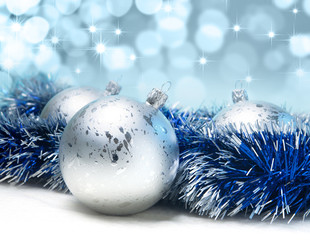 silver Christmas balls on a blue background
