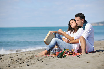 young couple enjoying  picnic on the beach