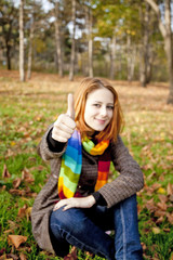 Portrait of red-haired girl in the autumn park.