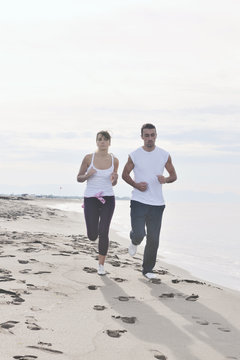 Couple Jogging On The Beach