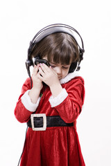 Christmas child with sell phone and headphones
