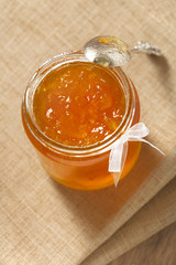 orange thin cut marmalade or jam  in  jar with spoon