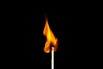 burning match on black background