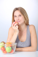 Closeup of beautiful woman holding red apple