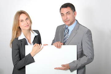 Business team showing white message board