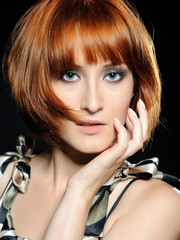 Beautiful red haired woman with fashion bob hairstyle and creati