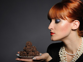 Beautiful elegant fashion woman with chocolate truffle sweets