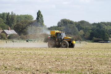 Tractor crop spraying field. West Sussex. England