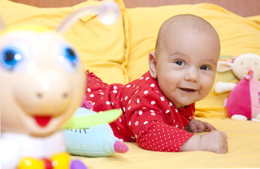 Fototapeta na wymiar Smiling babygirl in bed