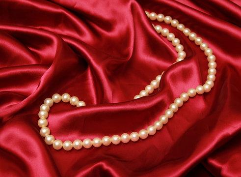 Pearl necklace on a luxury satin