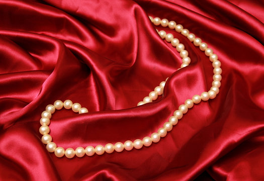 Pearl necklace isolated on a luxury satin