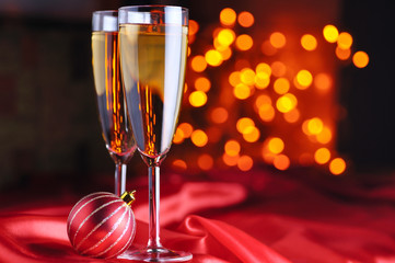 two champagne glasses on red silk